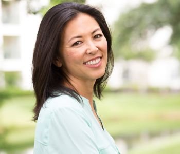 woman smiling with beautiful teeth after dental implant